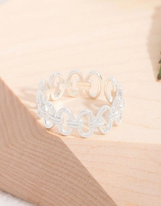 Detailed view of S925 sterling silver interlocking oval ring on a wooden surface