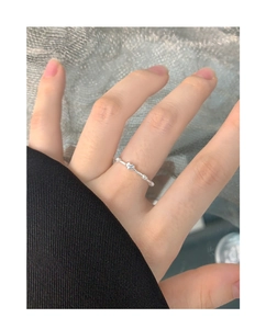 Detail of S925 sterling silver beaded ring with polished heart worn on the finger
