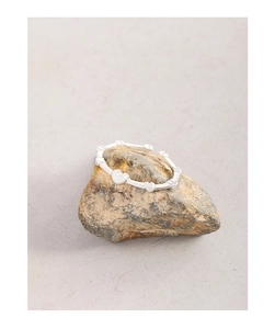 Detailed view of silver S925 heart-shaped adjustable ring on a natural stone surface