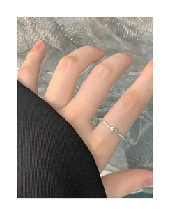 Close-up of S925 sterling silver heart ring with bamboo textured band on finger
