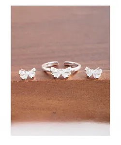 Detailed view of S925 silver bow and heart jewelry set including ring and stud earrings