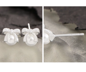Close-up of S925 sterling silver bow earrings with elegant pearl drop and hallmark