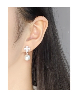 Close-up of S925 silver leaf earrings with zircon accents and round white pearls