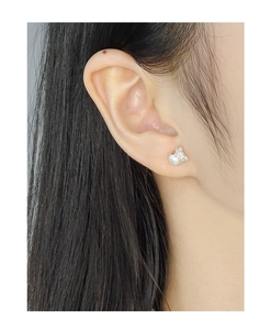 Close-up of S925 silver bow-shaped pearl stud earrings worn on a model's ear