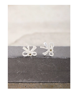 Gros plan de boucles d'oreilles nœud et fleur en argent S925 avec zircon sur pierre