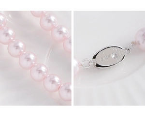Macro shot of S925 silver clasp and glossy pink pearls texture on a minimalist base