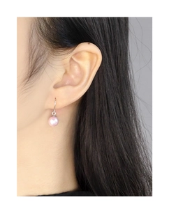 Close-up of elegant pink pearl drop earring on model featuring S925 silver hooks