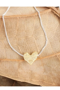 Detail showing S925 hallmark on a silver heart pendant with unique lava texture