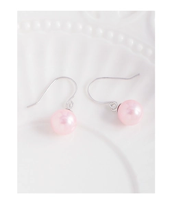 Macro shot of S925 sterling silver hooks with elegant pink pearls on ceramic surface