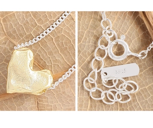 Macro detail of S925 sterling silver stamp on golden lava textured heart necklace
