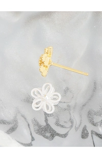Macro view of S925 sterling silver stamp and hollow flower stud earring details