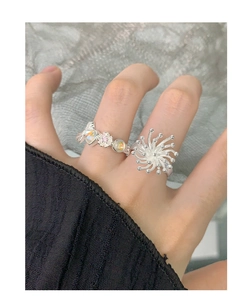 Detail of S925 sterling silver rings with floral opal and sunburst bead design