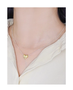 Detailed view of S925 silver heart necklace with unique gold-toned textured lava pendant