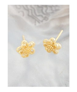 Macro shot of double-layer hollow flower stud earrings with textured gold finish