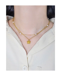 Close-up of double-layer S925 silver necklace with hollow flower pendant and pearls