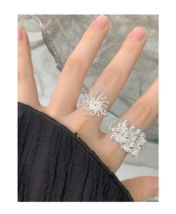 Detailed view of S925 sterling silver rings with fireworks and bead texture design