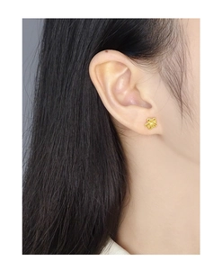 Detailed view of S925 silver double-layer hollow flower studs with matte gold finish