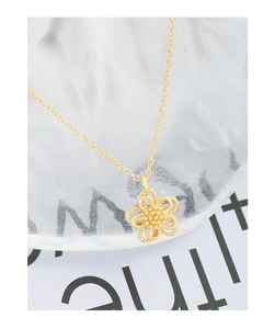 Macro shot of gold S925 silver double-layer hollow flower pendant necklace with O-chain