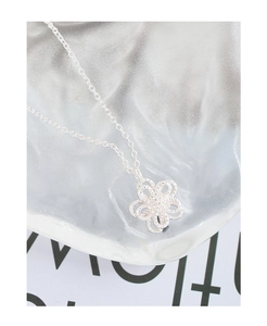 Close-up of S925 sterling silver necklace with a layered hollow flower petal pendant