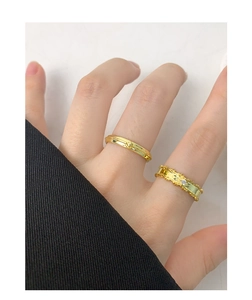 Detailed close-up of gold-plated leaf zircon rings with intricate braided texture