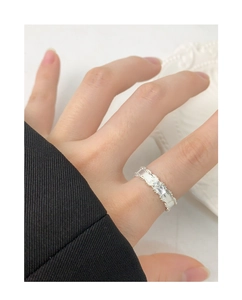 Macro detail of leaf design S925 silver ring with zircon stone on model's finger