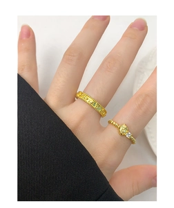 Detail of gold Sanrio characters embossed rings set with zircon on model's hand