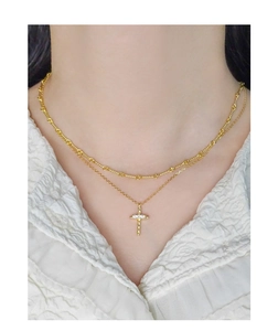 Detail of layered gold S925 sterling silver twist chain with zircon cross pendant necklace