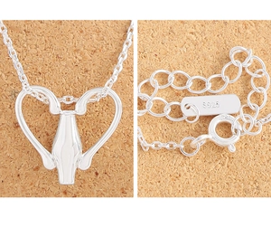 Detail view of S925 sterling silver stamp on the lobster clasp of a heart necklace