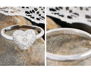 Macro detail of S925 sterling silver stamp on vintage heart ring with embossed pattern