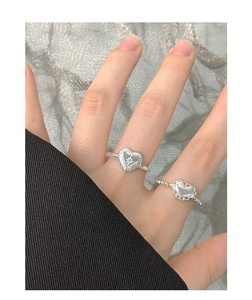 Detailed view of S925 sterling silver heart rings with vintage texture and zircon accents