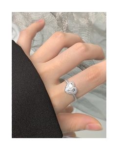 Detail of S925 sterling silver heart ring with vintage embossed textures on a model
