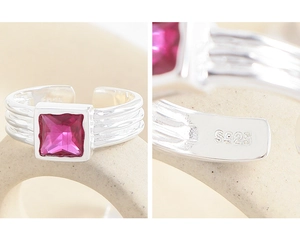 Detailed macro view of S925 sterling silver ring with textured band and pink zircon stone