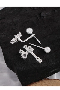Close-up of S925 sterling silver earring post showing clear hallmark on luxury zircon bow