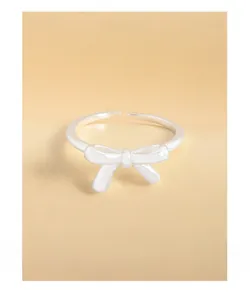 Detailed view of a polished silver bow-shaped open ring with a minimalist elegant design