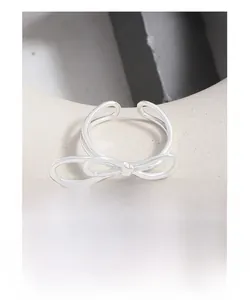 Detailed view of S925 sterling silver double-layer bow ring with minimalist open design