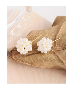 Macro detail of S925 silver stud earrings with cluster of white natural pearls