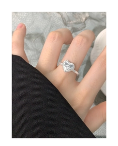 Detailed macro shot of vintage engraved heart ring with zircon on s925 silver band