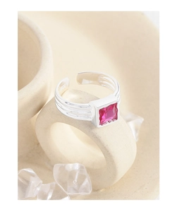 Macro shot of S925 sterling silver stamp and square red zircon on textured band ring