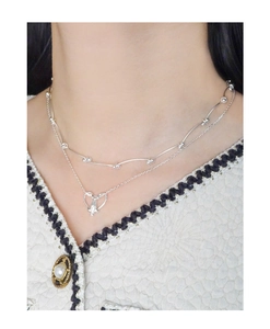 Close-up of double-layer S925 silver necklace with bead chain and hollow heart pendant