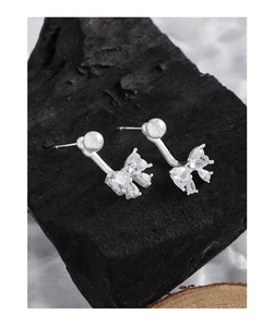 Detailed close-up of S925 sterling silver bow earrings with sparkling cubic zirconia