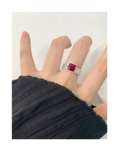 Close-up of S925 silver ring featuring a square red zircon and textured band on finger