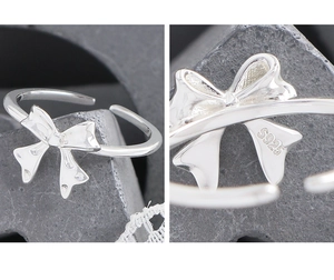 Close-up of S925 hallmark on polished silver bow-knot adjustable open ring