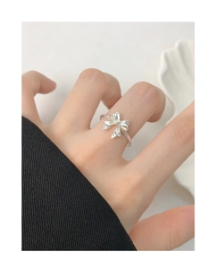 Close-up of S925 sterling silver bow ring worn on finger with minimalist decor