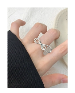 Close-up of a double-layered S925 sterling silver bow ring worn on a woman finger