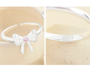 Close-up of S925 sterling silver bow ring with pink zircon and hallmark detail