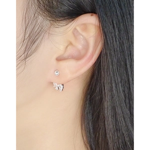 S925 sterling silver bow knot stud earrings with zircon stones worn by a model