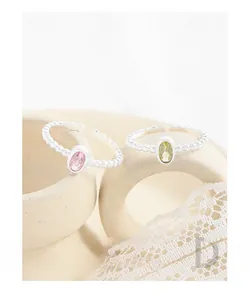 Detail of S925 silver beaded open rings with pink and green oval zircon stones