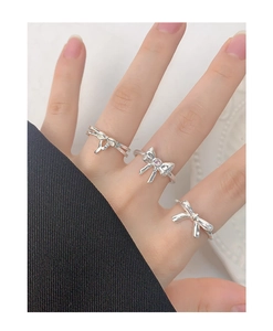 Macro detail of S925 silver bow rings with pink zircon stone on model's hand