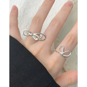 Elegant S925 sterling silver double-layer bow ring set for women on a textured background