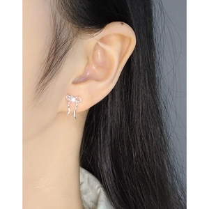 S925 sterling silver bow knot stud earrings with zircon stone shown on model ear